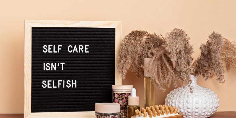 Self care is not selfish. Felt letter board with body and mind care products. Love yourself, physical and mental health concept